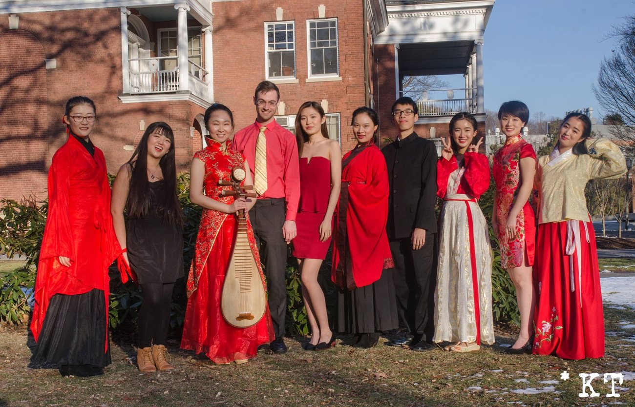 Chinese music ensemble performing on stage in traditional dress